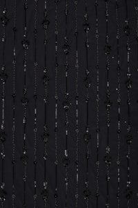 Black fabric with floral and bead patterns