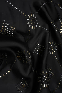 Black fabric with gold and silver embellishments