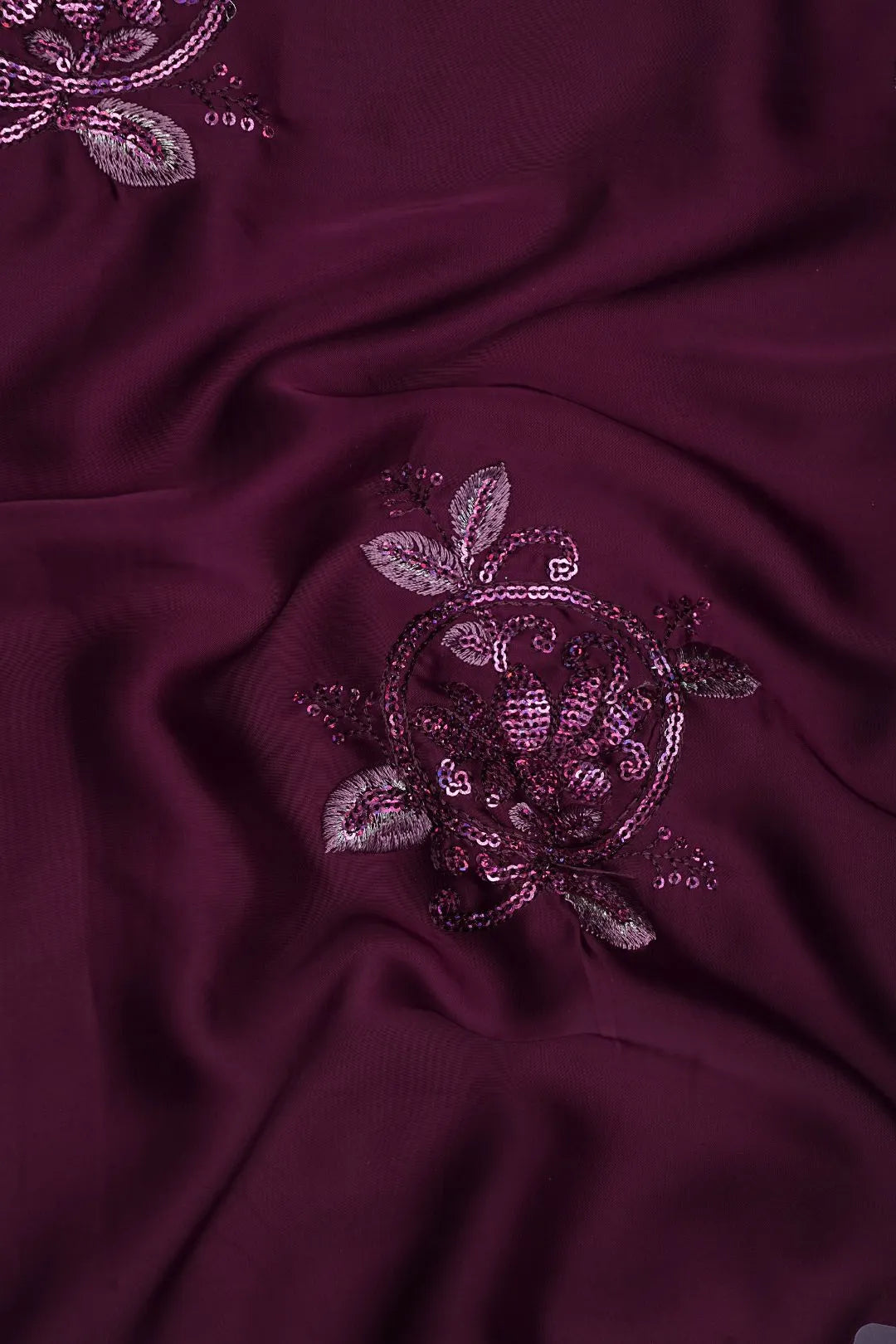 Burgundy fabric with floral sequin embroidery