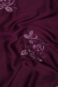 Burgundy fabric with floral sequin embroidery