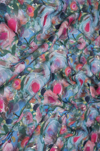 Colorful floral pattern fabric with pink, blue, and green colors.