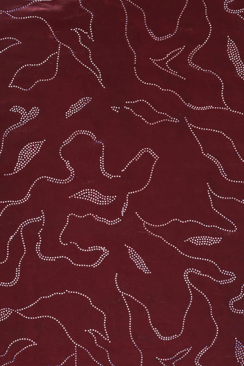 Maroon fabric with white floral patterns