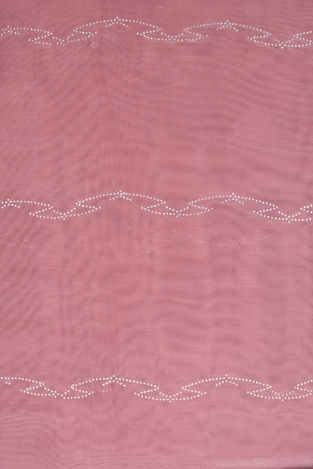 Pink fabric with decorative white stitching pattern