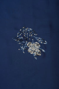 Sequined design on a dark blue fabric